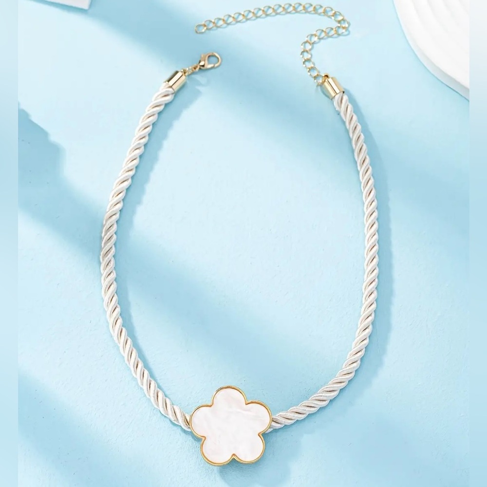 White big clover pendant on a thick twisted white rope design.